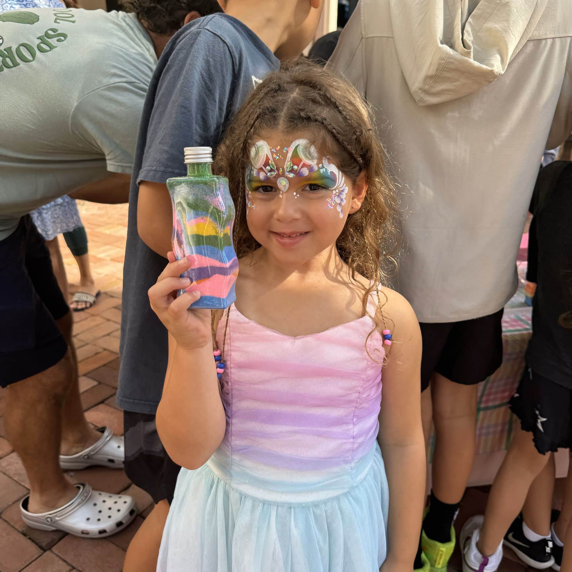Girl hold Sand Adventure bottle